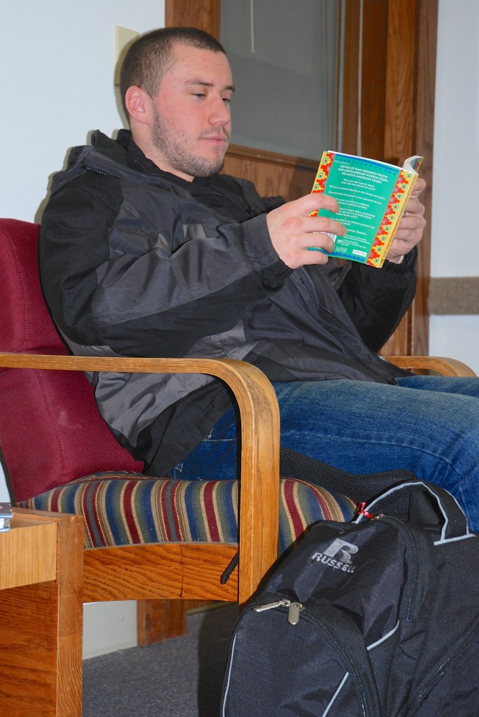Josh Gaedke gets a little reading in as he waits to meet with Director Karen Gagnon to discuss his financial aid.