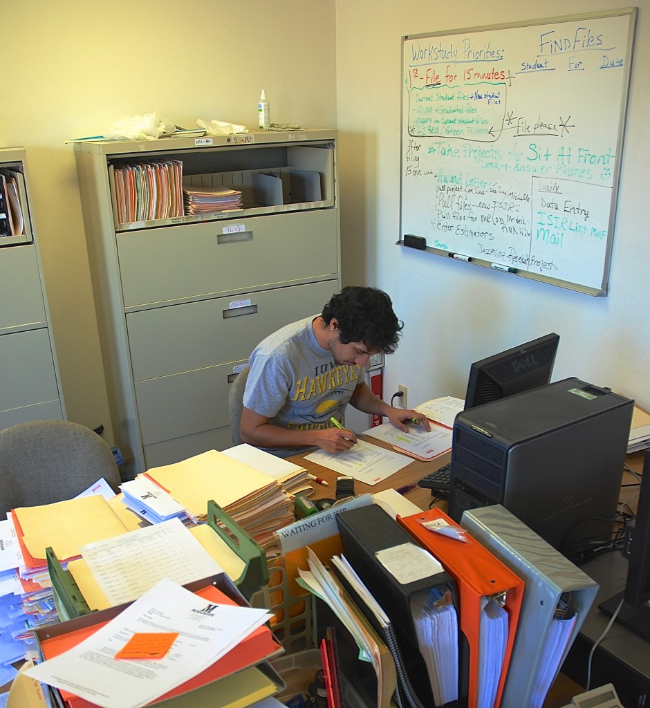 Fernando Franco keeps busy in between classes and homework by putting in a few hours a day at his work study job in the Financial Aid office at Morningside College.