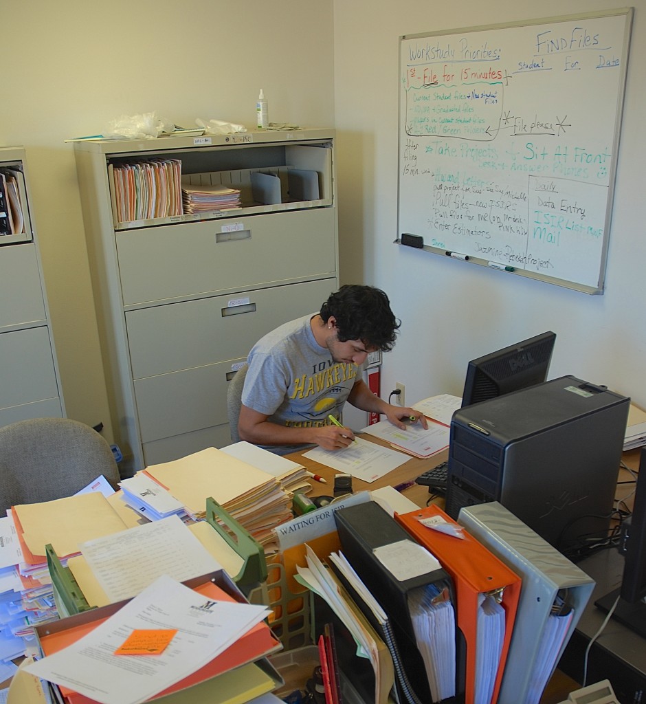 Fernando Franco, a senior attending Morningside College, working his way through a stack of files at his work-study job on campus. Contact the Morningside Financial Aid Office today to learn if you qualify and possible openings on campus.