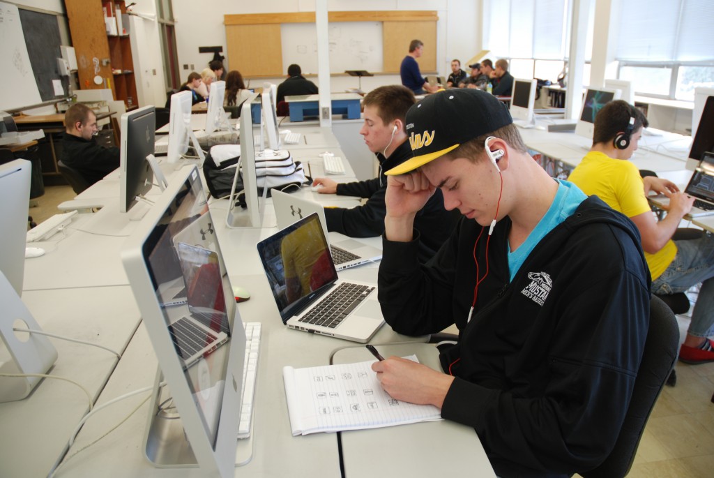 Drew Dau, and his fellow peers, hard at work in their Graphic Design class, working on some drafts for his next assignment.