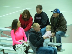 A family chatting before a wresting meet.