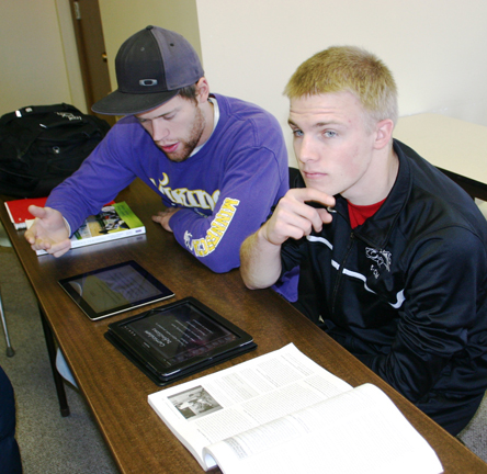 Students Kyle Huggenberger (left) and Cameron Meter use iPads in an education class.
