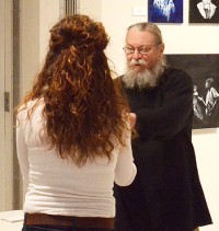Art Dept. Chair John Bowitz presents Cameron Oakley with an award during a gallery reception.
