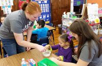Summer Beery (left) and Sara Wede (right) lead an activity at Hunt Elementary.
